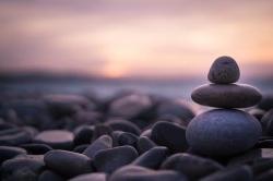 Sunset with pebbles on beach in Nice, France.